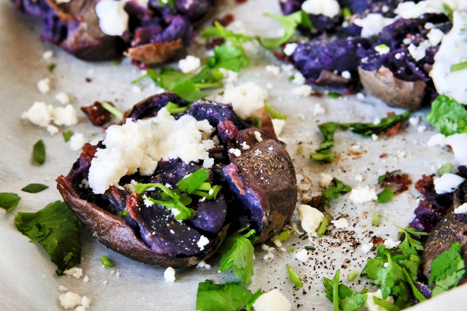 Smashed Purple Potatoes smashed potatoes, easy smashed potato recipe, side dish recipes, potato side dish recipe, easy potato recipes, easy potato side dish recipe, purple potato recipes, cilantro crema, cilantro sour cream, side dish recipes