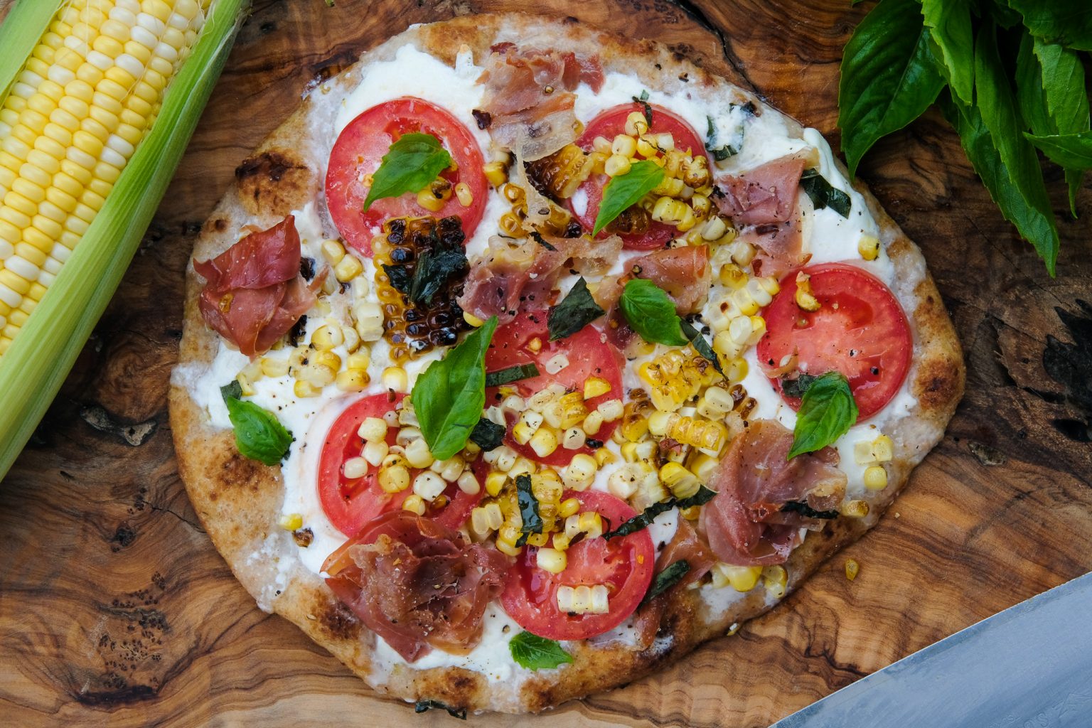 pizza with burrata, pizza with corn, pizza with prosciutto, naan pizza, summer pizza, easy pizza recipe, pizza recipe using naan, tomato corn pizza, pizza with burrata and tomato recipe, homemade pizza recipe
